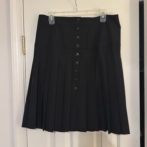 Pleated black skirt with button front
